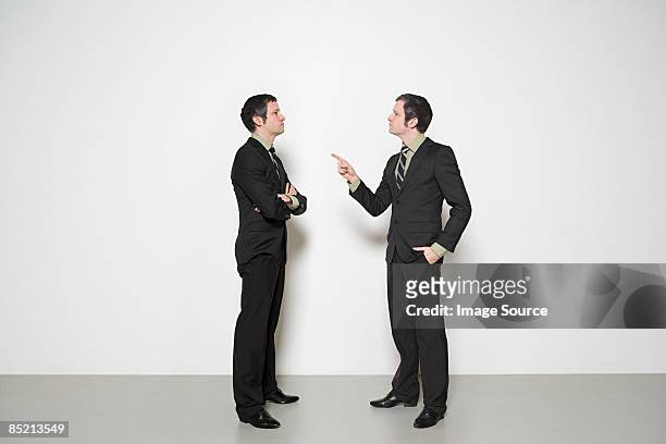 businessman arguing with himself - multiple images of same person stock pictures, royalty-free photos & images