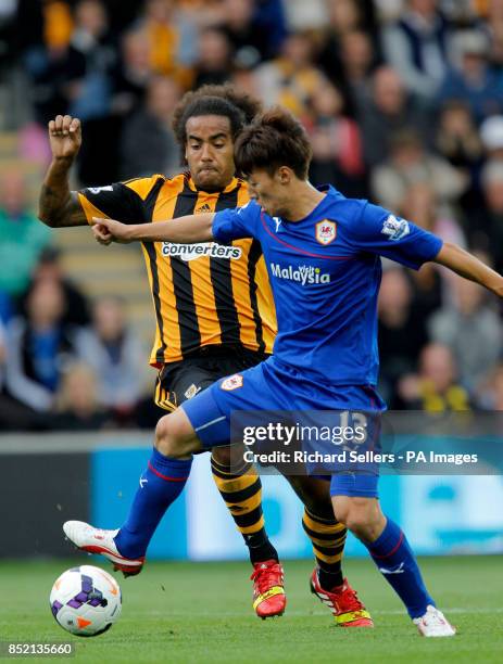 Cardiff City's Kim Bo Kyung and Hull City Tigers' Tom Huddlestone during the Barclays Premier League match at the KC Stadium, Hull.