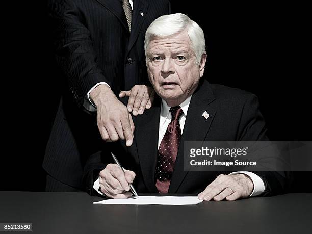 politician being made to sign - fear of writing stock pictures, royalty-free photos & images