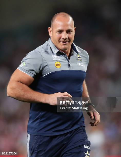 Injured Cowboys player Matt Scott assists Cowboys warm up during the NRL Preliminary Final match between the Sydney Roosters and the North Queensland...
