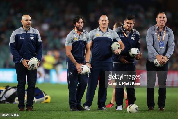 Injured Cowboys players Johnathan Thurston and Matt Scott assist Cowboys warm up during the NRL Preliminary Final match between the Sydney Roosters...