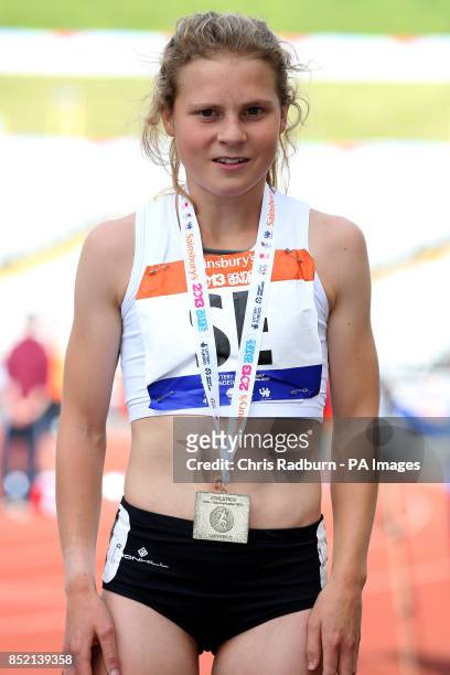 England South East's Bobby Clay receives her gold medal for girls 1500m on day three of the 2013 Sainsburys School Games at Don Valley Stadium,...