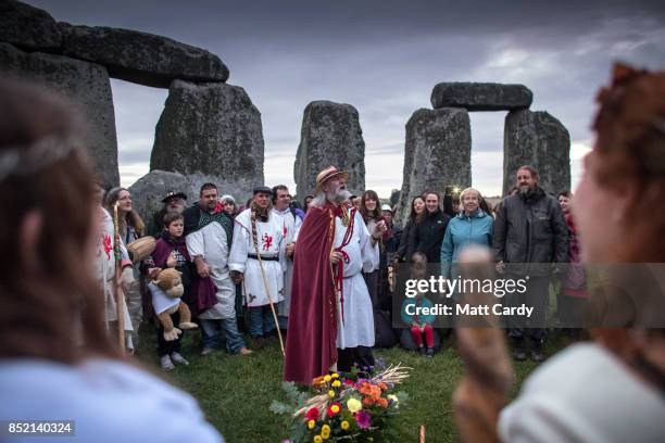 Rollo Maughfling, Archdruid of Stonehenge and Britain conducts a ceremony as druids, pagans and revellers gather in the centre at Stonehenge, hoping...