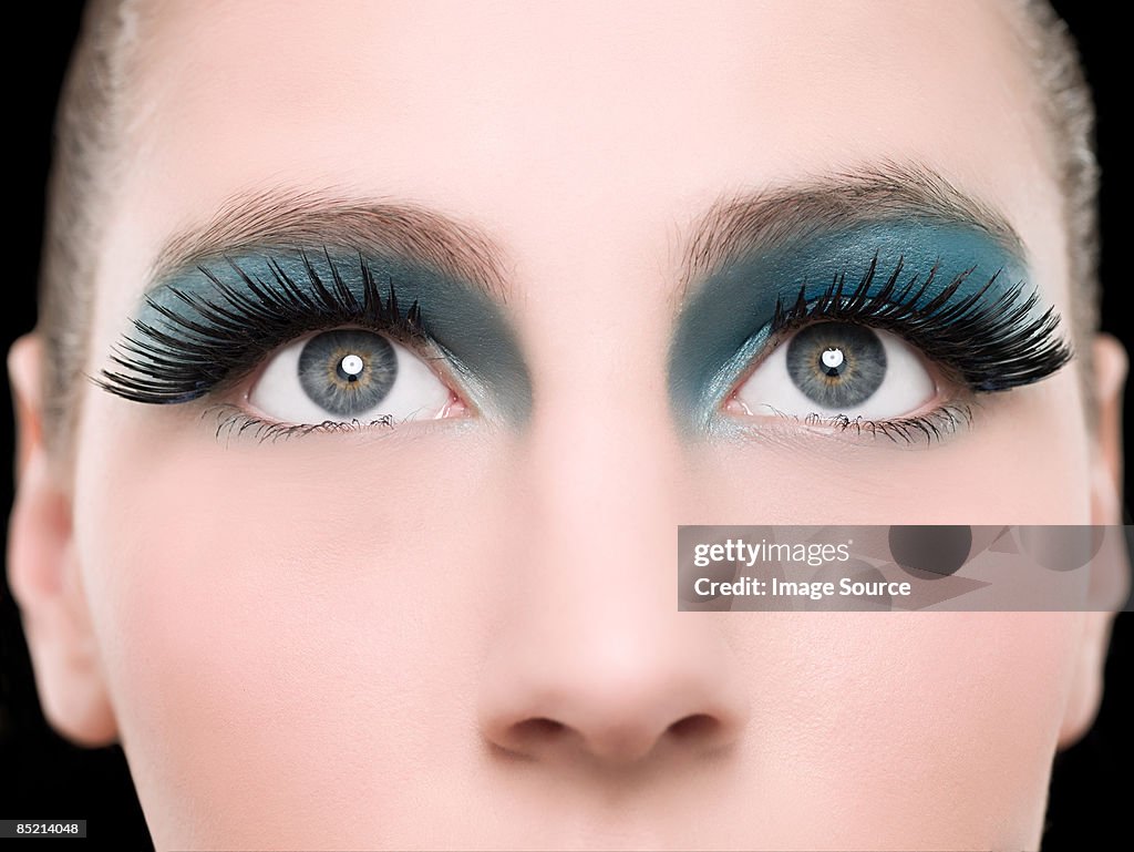 A young woman wearing false eyelashes
