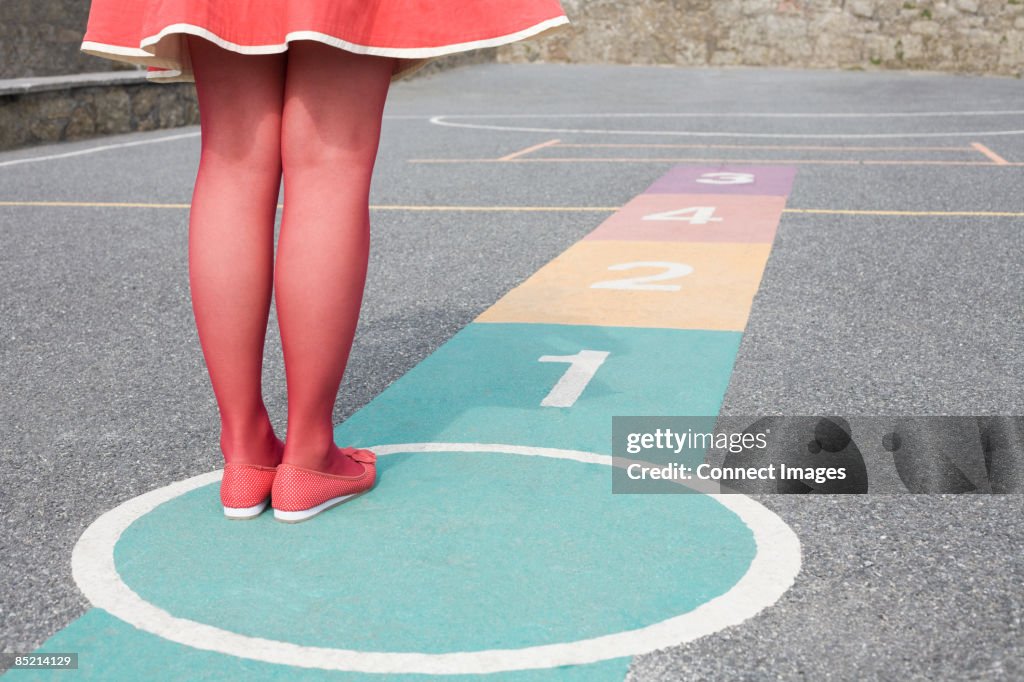 Woman playing hopscotch