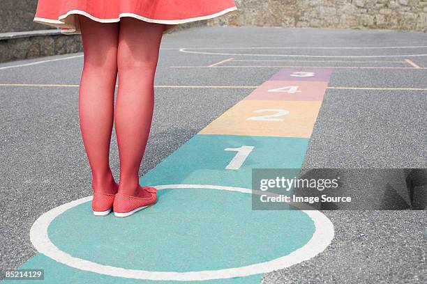 woman playing hopscotch - hopscotch stock pictures, royalty-free photos & images