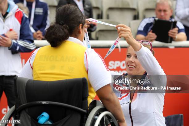 Hannah Cockroft presents a bronze medal to Doaa Sahyea for wheelchair 200m on day three of the 2013 Sainsburys School Games at Don Valley Stadium,...