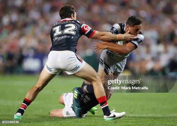 Te Maire Martin of the Cowboys is tackled by Aidan Guerra of the Roosters during the NRL Preliminary Final match between the Sydney Roosters and the...