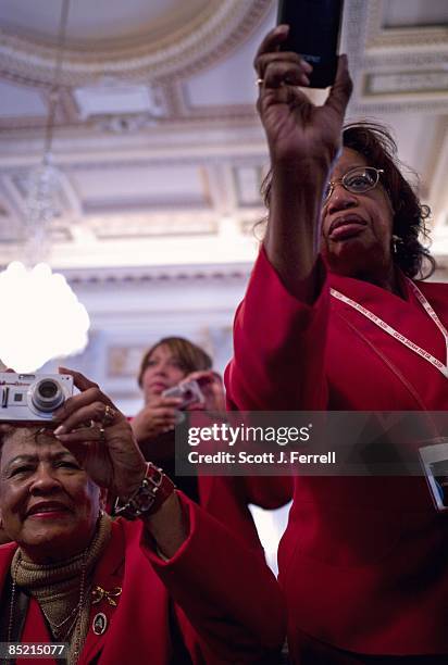 March 03: Delta Sigma Theta Sorority members take pictures of VIPs, including House Speaker Nancy Pelosi, D-Calif., as they unveil a portrait of...