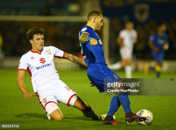 Robbie Muirhead of MK Dons and AFC Wimbledon's Barry Fuller during Sky Bet League One match between AFC Wimbledon and MK Dons at Kingsmeadow Stadium,...