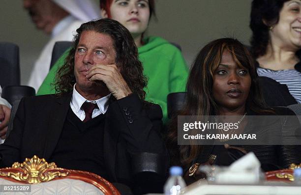 The French coach of Qatar's national football team Bruno Metsu and his wife watch a friendly testimonial football match between Al-Sadd and AC Milan...