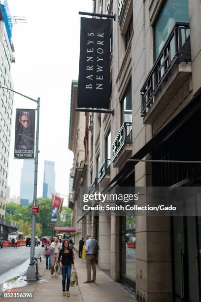 People walk past the facade of the Barneys New York department store on 60th street off Madison Avenue in Manhattan, New York City, New York,...