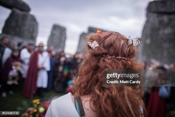 Druids, pagans and revellers gather in the centre at Stonehenge, hoping to see the sun rise, as they take part in a autumn equinox celebrations at...