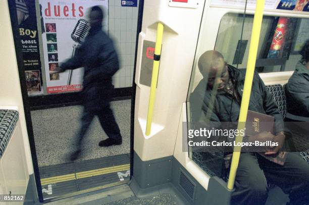 Passenger sleeps while travelling in the Northern Line of The London Underground system November 15, 2000 in London, England. The London Underground...