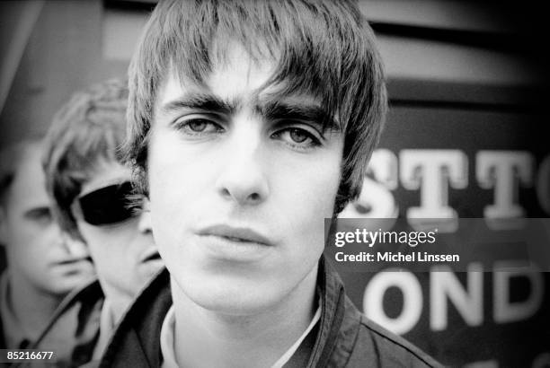 Photo of Liam GALLAGHER and OASIS, Liam Gallagher, with Noel Gallagher behind - posed