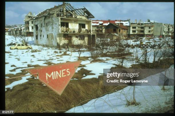 Signs stands in front of destroyed buildings March 5, 1996 in Sarajevo, Bosnia-Herzegovina. The city is reopening its businesses, repairing damages...