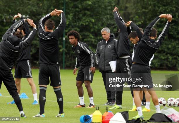 Chelsea's manager Jose Mourinho with Willian during a training session at Cobham Training Ground, Stoke D'Abernon.