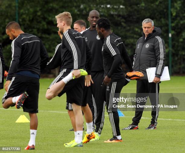 Chelsea's manager Jose Mourinho watches his players during a training session at Cobham Training Ground, Stoke D'Abernon.