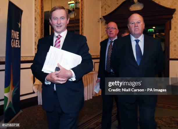 Taoiseach Enda Kenny, Chairperson of the Fine Gael Charles Flanagan and Finance Minister Michael Noonan, arrive for a press conference at the Fine...