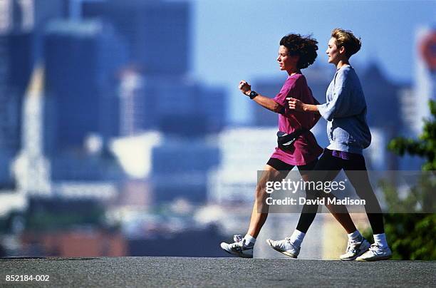 two women speed walking in city, san francisco, california, usa - power walking stock-fotos und bilder