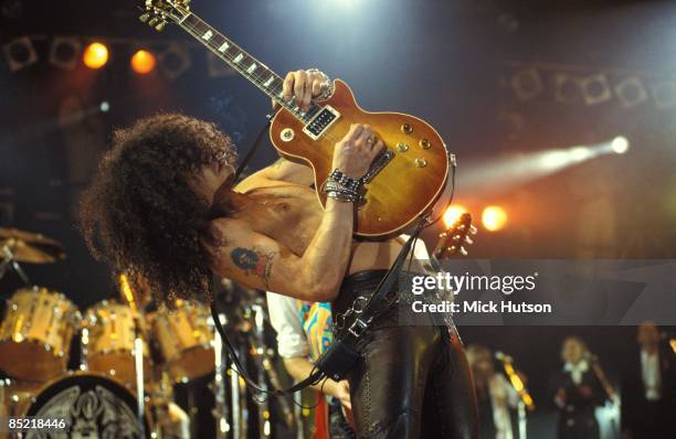 Photo of GUNS & ROSES and SLASH and GUNS N' ROSES and GUNS AND ROSES, Slash performing live onstage at the Freddie Mercury Tribute Concert, playing...