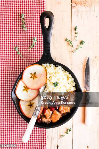 pork stew with dried cranberry served with couscous in a pan, selective focus - homemade apple sauce stock pictures, royalty-free photos & images