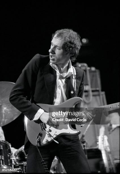 Photo of DIRE STRAITS and Mark KNOPFLER, Mark Knopfler performing live onstage, playing Fender Stratocaster guitar
