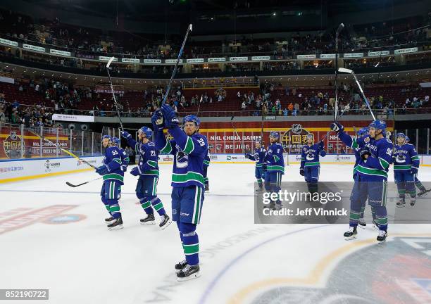 Vancouver Canucks captain Henrik Sedin and the rest of the team salute the fans after their pre-season game against the Los Angeles Kings at Cadillac...