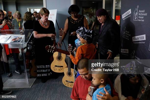 Ronald McDonald House Founding Ambassador Steven Van Zandt poses with pediatric cancer patients after donating bandanas and 95 guitars at the...