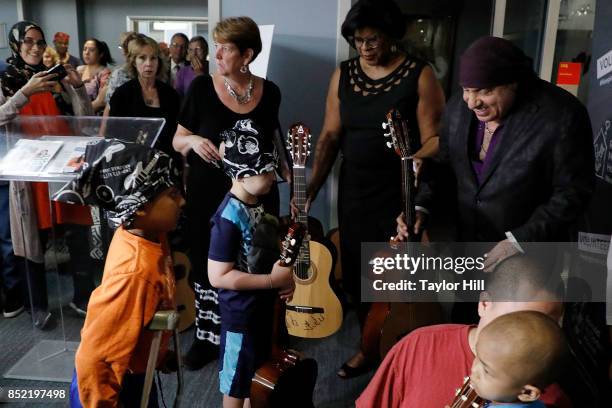 Ronald McDonald House Founding Ambassador Steven Van Zandt poses with pediatric cancer patients after donating bandanas and 95 guitars at the...