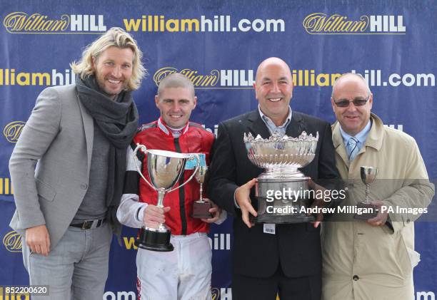 Robbie Savage after handing out the Kilkerran Cup to jockey Tony Hamilton , owner Ronnie Devlin and trainer Richard Fahey after their horse Hi There...