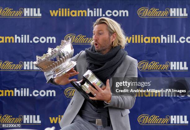 Robbie Savage prepares to hand out the Kilkerran Cup after the horse Hi There won The William Hill Download The App Handicap Stakes during Day One of...