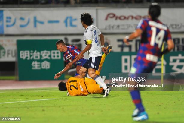 Dudu of Ventforet Kofu is challenged by Hiroki Iikura of Yokohama F.Marinos resulting in a penalty kick during the J.League J1 match between...