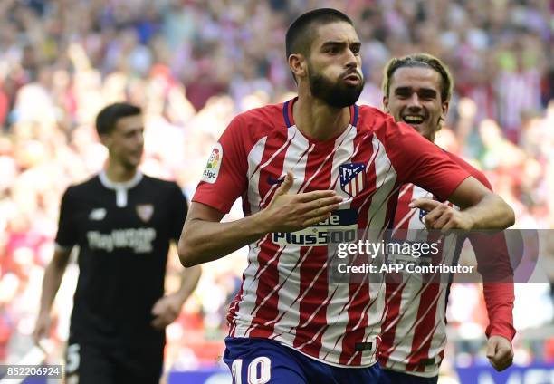 Atletico Madrid's midfielder from Belgium Yannick Ferreira-Carrasco celebrates a goal beside Atletico Madrid's forward from France Antoine Griezmann...