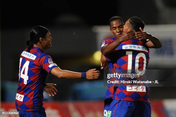 Lins of Ventforet Kofu celebrates scoring his side's third goal with his team mates Yusuke Tanaka and Dudu during the J.League J1 match between...