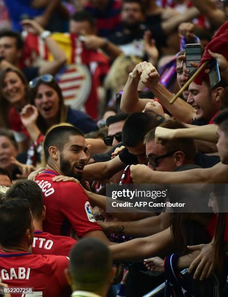 Atletico Madrid's midfielder from Belgium Yannick Ferreira-Carrasco celebrates a goal with fans during the Spanish league football match Club...