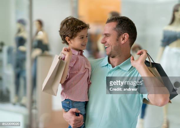happy father and son at the shopping center - boy clothes stock pictures, royalty-free photos & images