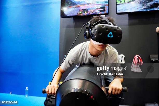 Visitor wearing VR headset plays VR simulator at the JPW international booth during the Tokyo Game Show 2017 at Makuhari Messe on September 23, 2017...