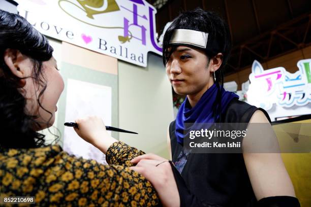 Visitor tries out the reality romance game at the Voltage booth during the Tokyo Game Show 2017 at Makuhari Messe on September 23, 2017 in Chiba,...