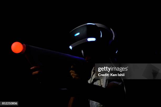 Visitor wearing VR headset plays the Bravo Team video game at the Sony Interactive Entertainment Inc. During the Tokyo Game Show 2017 at Makuhari...