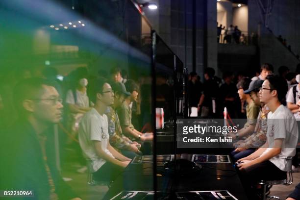 Visitors play the Winning Eleven 2018 video game at the Konami Holdings Corp. Booth during the Tokyo Game Show 2017 at Makuhari Messe on September...