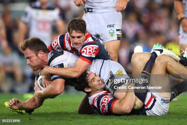 Gavin Cooper of the Cowboys is tackled during the NRL Preliminary Final match between the Sydney Roosters and the North Queensland Cowboys at Allianz...