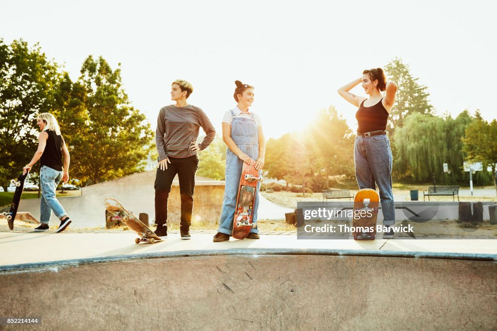 Female friends hanging out during summer morning skate session