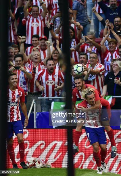 Atletico Madrid's forward from France Antoine Griezmann celebrates a goal with Atletico Madrid's midfielder from Spain Koke during the Spanish league...
