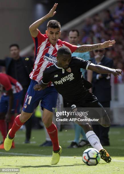Atletico Madrid's forward from Argentina Angel Correa vies with Sevilla's defender from France Lionel Carole during the Spanish league football match...