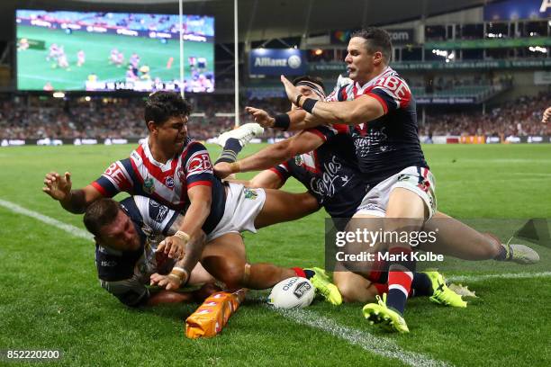 Kyle Feldt of the Cowboys scores in the corner as he is tackled during the NRL Preliminary Final match between the Sydney Roosters and the North...