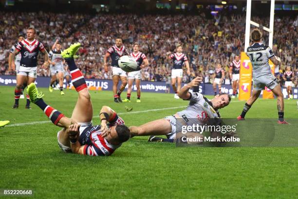Lachlan Coote and Kane Linnett of the Cowboys celebrate Kane Linnett scoring a try during the NRL Preliminary Final match between the Sydney Roosters...