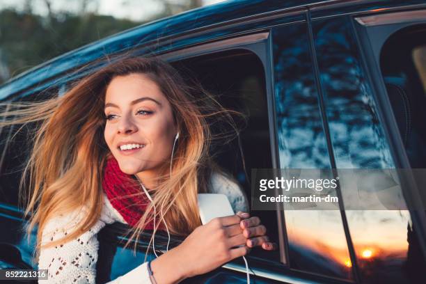 adolescente sur la vitre de la voiture le coucher du soleil - car top view photos et images de collection