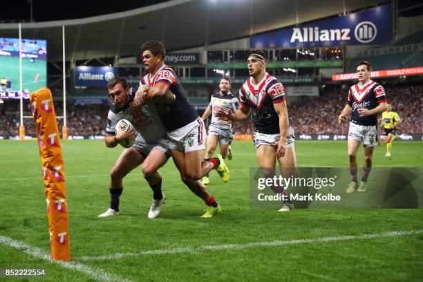 Kyle Feldt of the Cowboys scores in the corner as he is tackled during the NRL Preliminary Final match between the Sydney Roosters and the North...