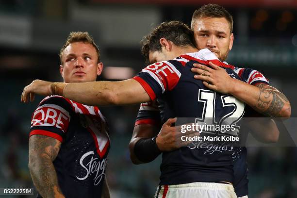 Jake Friend, Aidan Guerra and Jared Waerea-Hargreaves of the Roosters look dejected after defeat during the NRL Preliminary Final match between the...